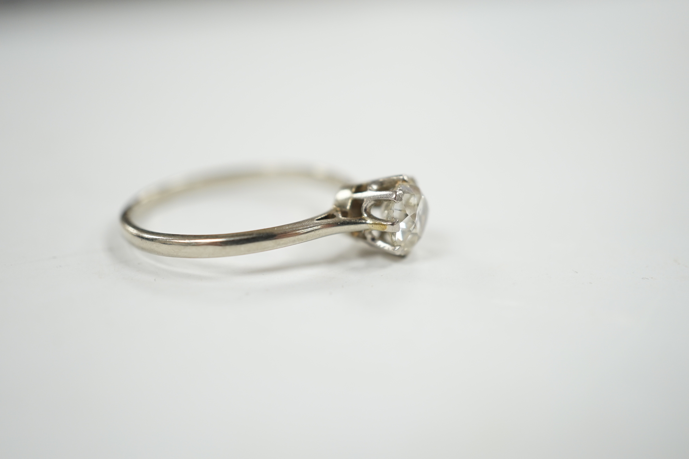 A white metal and solitaire diamond set ring, size Q, gross weight 2.1 grams